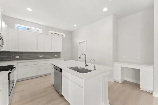 a kitchen with a sink and cabinets