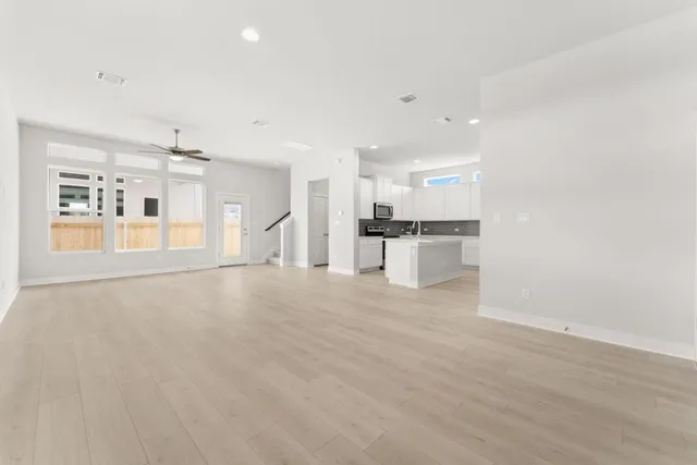a view of a kitchen with a sink and a refrigerator