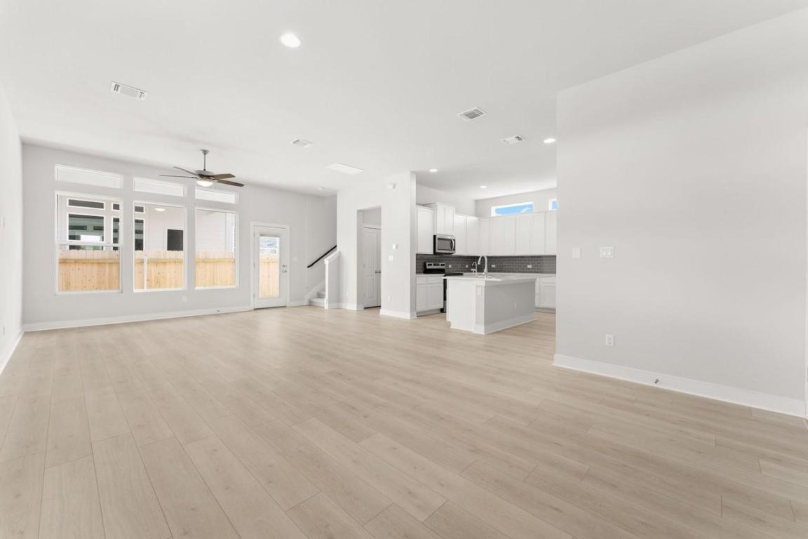 2200 Grenache Drive, Unit 105 Round Rock, TX 78664 - Photo 8 of 15 a view of a kitchen with a sink and a refrigerator