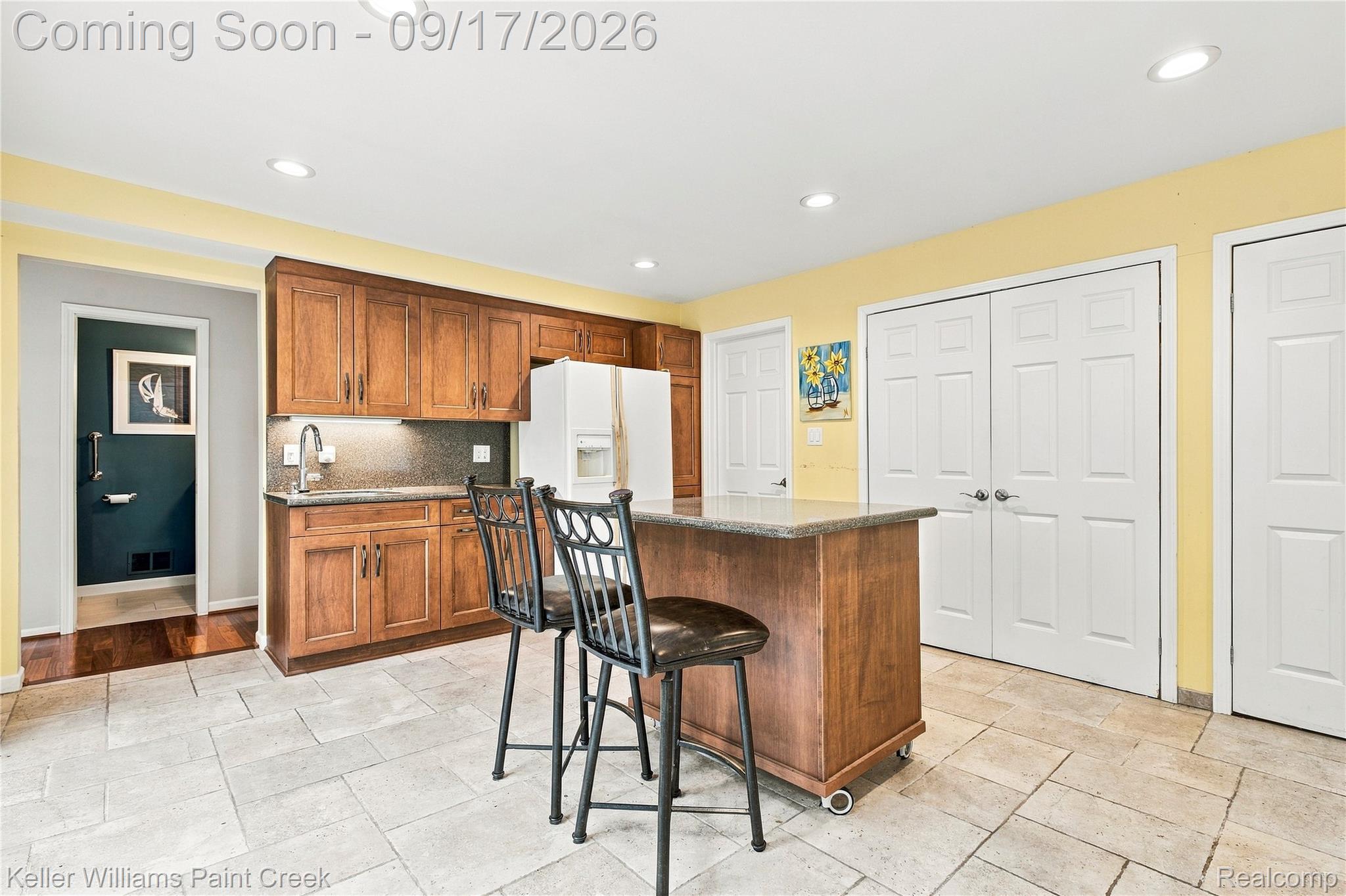 4535 Orion Road Rochester, MI 48306 - Photo 31 of 67 Kitchen featuring wood cabinetry, a center island with a stone countertop, under-cabinet lighting, and recessed ceiling lights