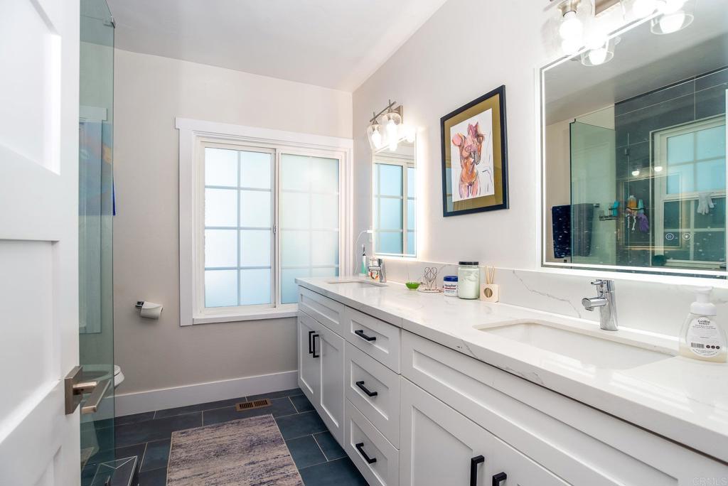 4776-78 Del Monte Avenue San Diego, CA 92107 - Photo 12 of 45 a bathroom with double vanity sink a mirror and a window