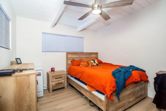 a bed room with a bed and a desk