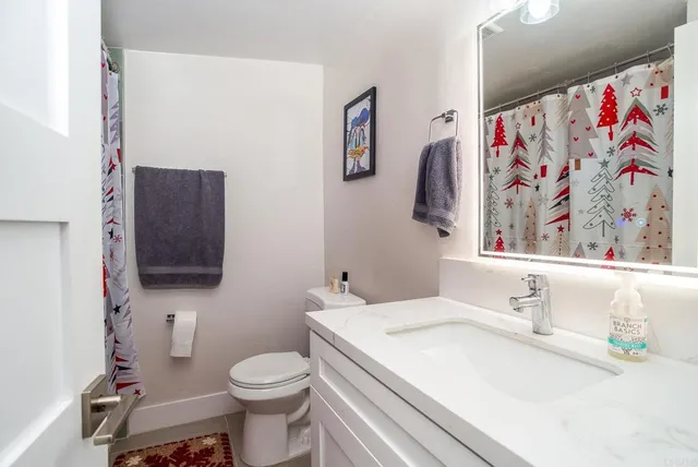 a bathroom with a sink toilet and mirror
