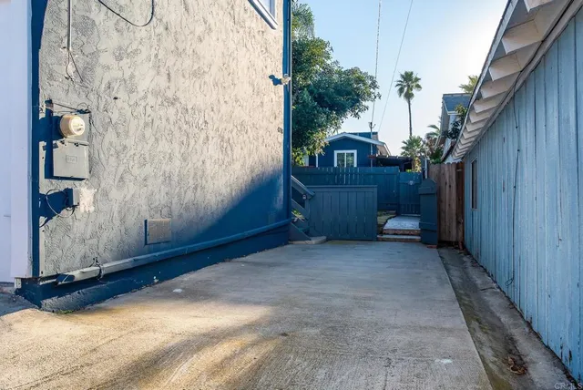a view of a house with a wooden fence