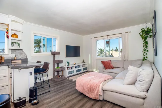 a bedroom with furniture and a flat screen tv