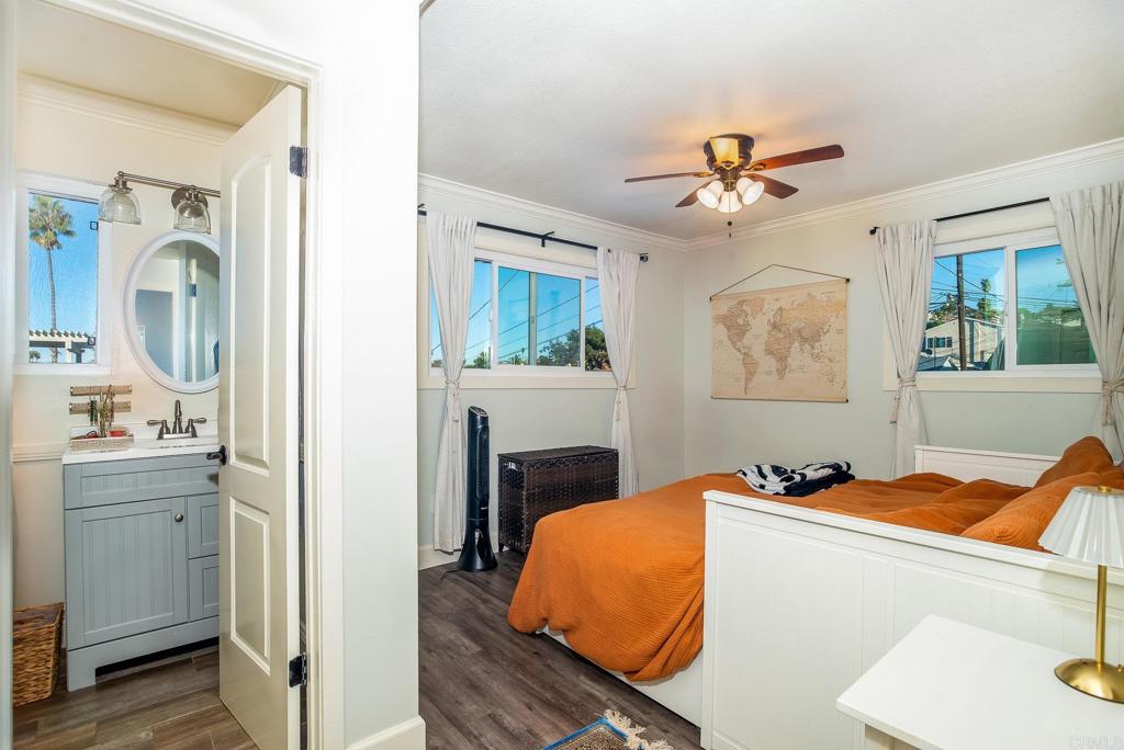 4776-78 Del Monte Avenue San Diego, CA 92107 - Photo 37 of 45 a bedroom with a bed and a chandelier