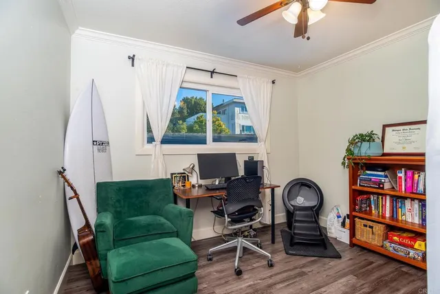 a living room with furniture a window and wooden floor