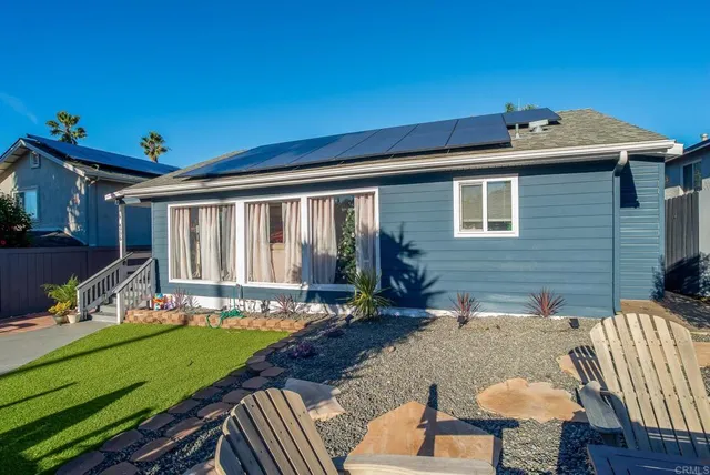 a front view of house with a garden and patio