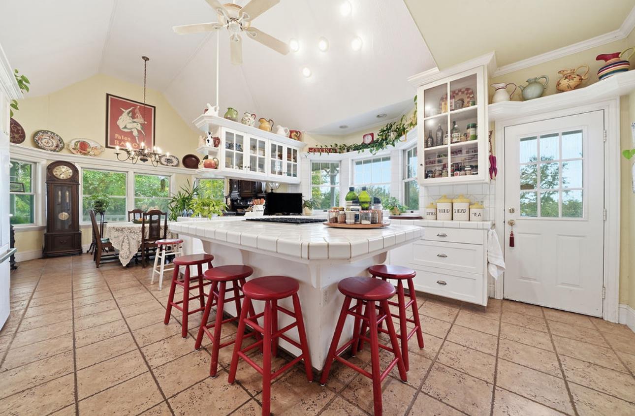 22140 North Clements Clements, CA 95227 - Photo 61 of 88 a kitchen with stainless steel appliances kitchen island granite countertop a table chairs and a refrigerator