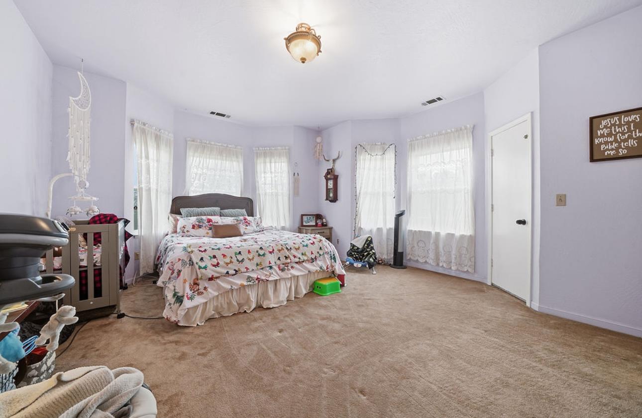 22140 North Clements Clements, CA 95227 - Photo 69 of 88 a bedroom with a bed a couch and a window