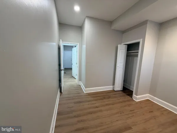 a view of hallway with wooden floor