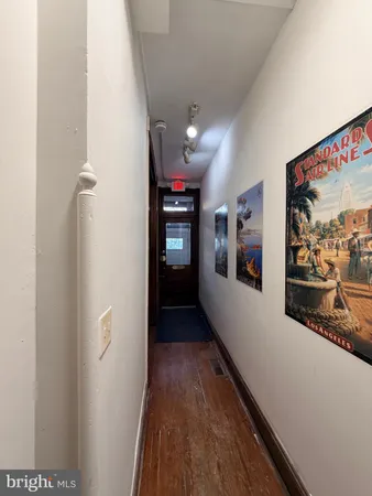 a view of a hallway with wooden floor