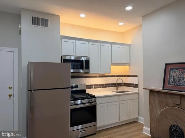 a kitchen with a refrigerator and a sink