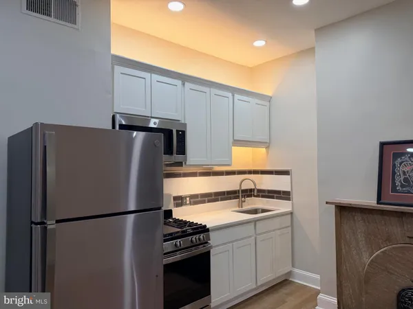 a white refrigerator freezer sitting inside of a kitchen