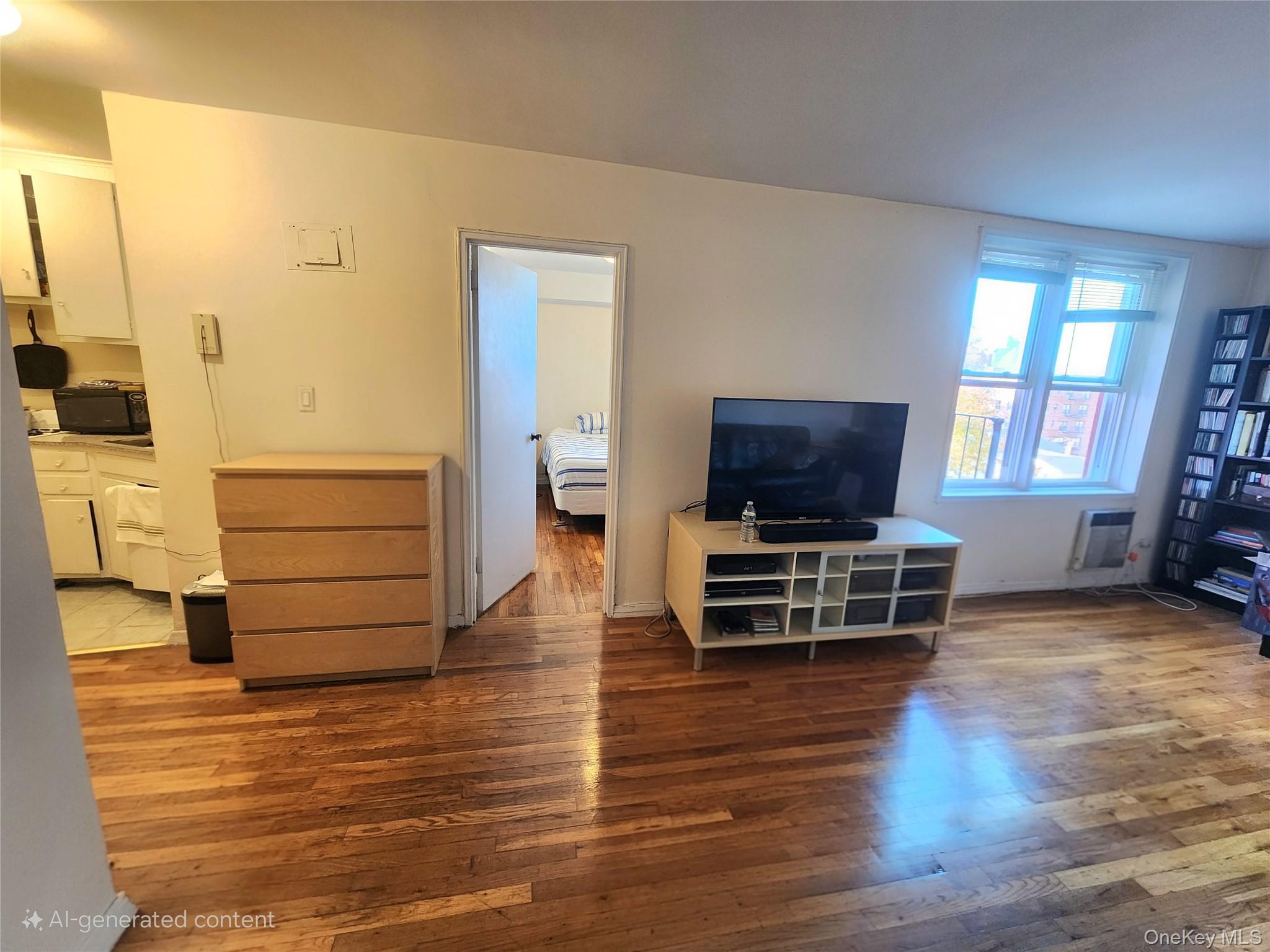 50-22 40th Street, Unit 5A Queens, NY 11104 - Photo 2 of 13 a living room with furniture and a flat screen tv