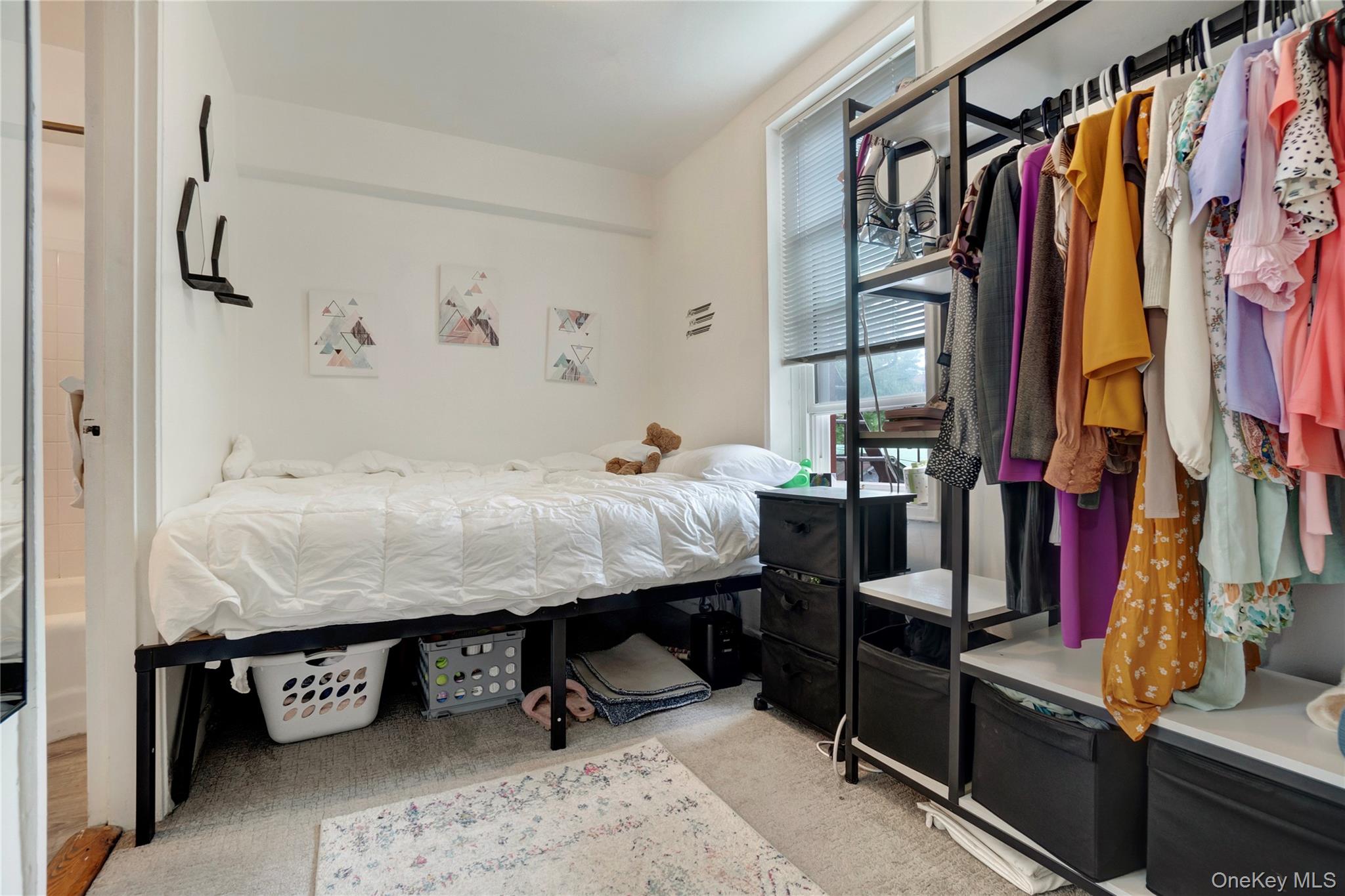 50-22 40th Street, Unit 5A Queens, NY 11104 - Photo 3 of 13 a bed room with a bed and a couch