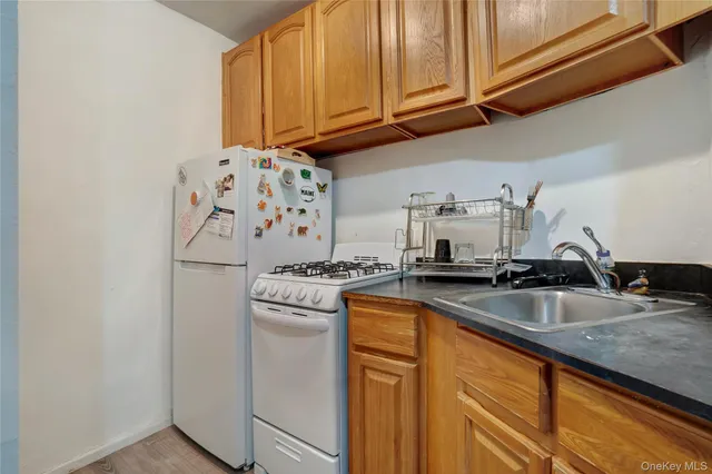 a kitchen with granite countertop a sink and cabinets