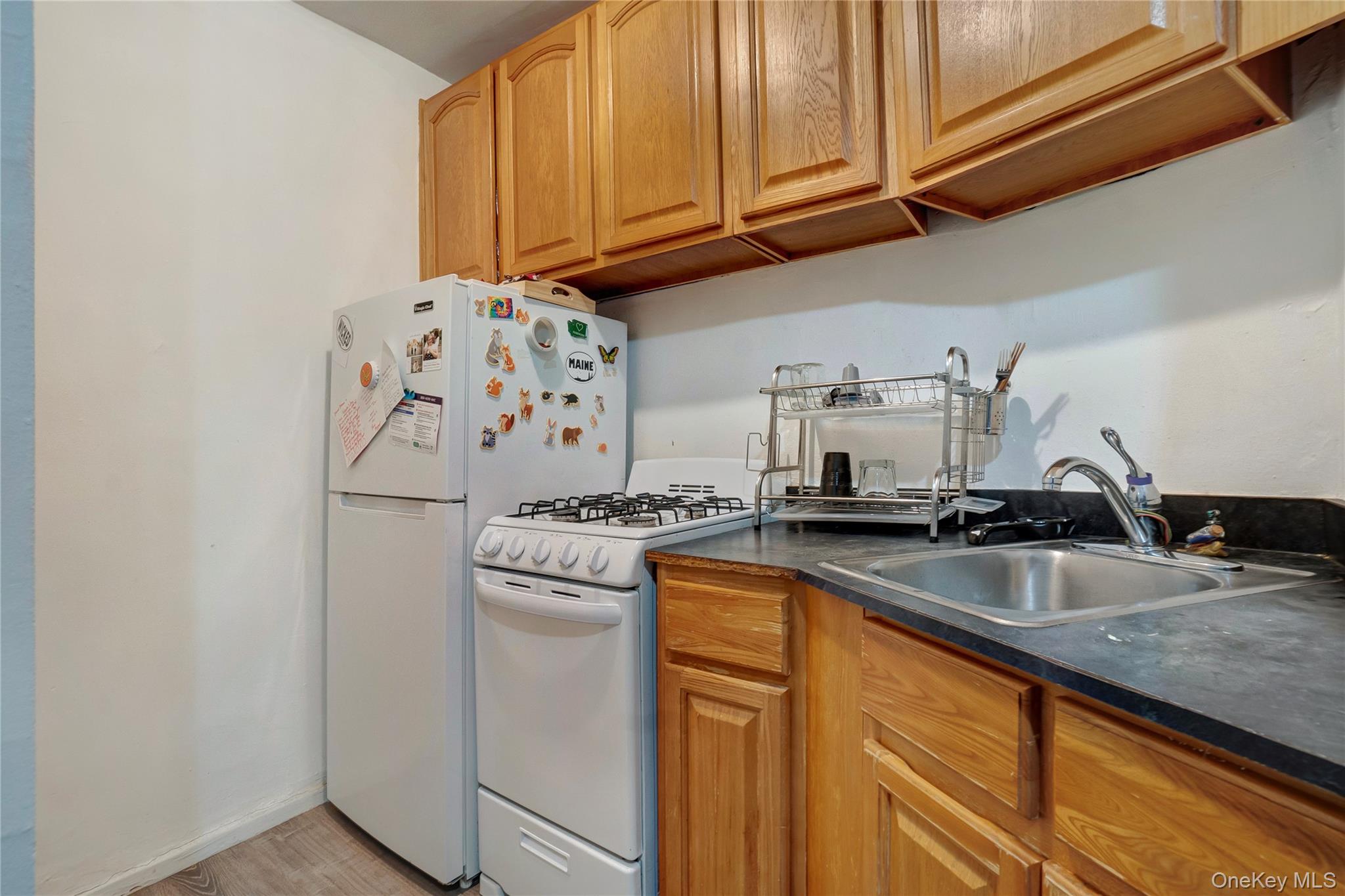 50-22 40th Street, Unit 5A Queens, NY 11104 - Photo 5 of 13 a kitchen with granite countertop a sink and cabinets