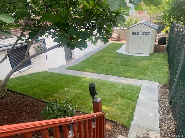 50-22 40th Street, Unit 5A Queens, NY 11104 - Photo 8 of 13 a view of a house with a yard and a large tree