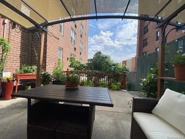 a view of table and chair with potted plants