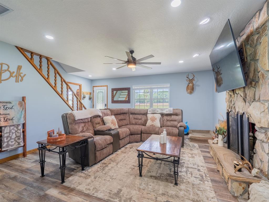 4381 Northeast 105th Place Anthony, FL 32617 - Photo 18 of 49 a living room with furniture a rug and a flat screen tv