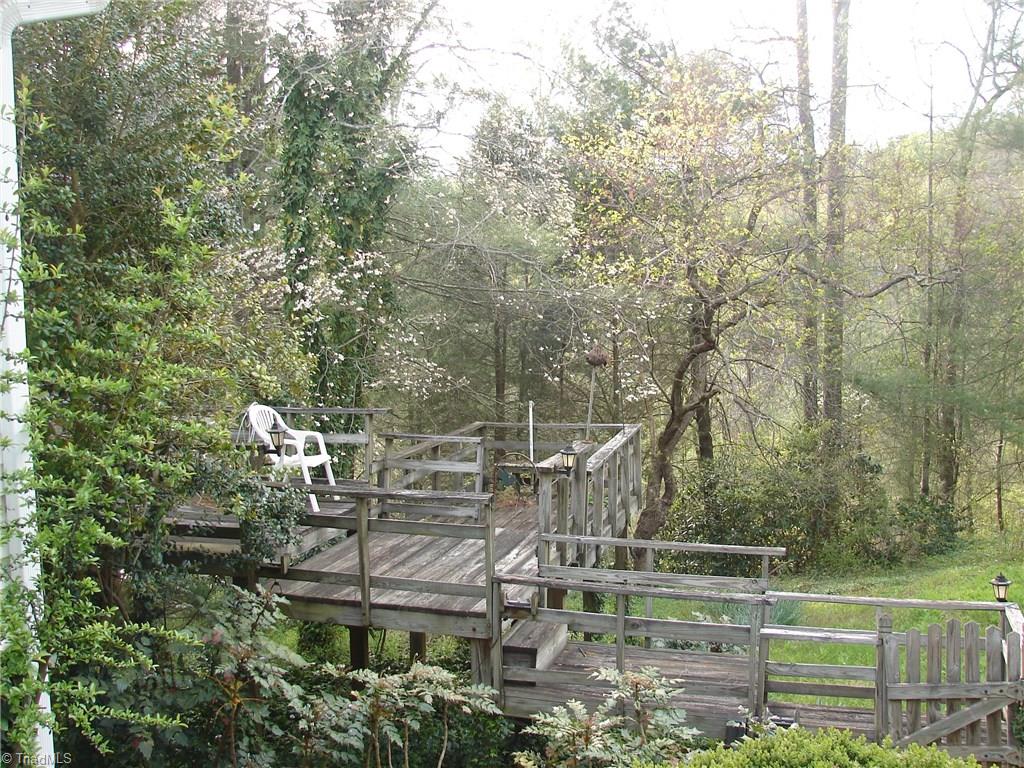 Multi-level deck overlooking backyard and pond