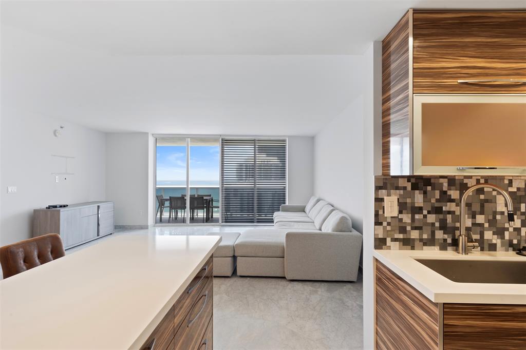 18911 Collins Avenue, Unit 3003 Sunny Isles Beach, FL 33160 - Photo 15 of 53 a living room with furniture and a large window