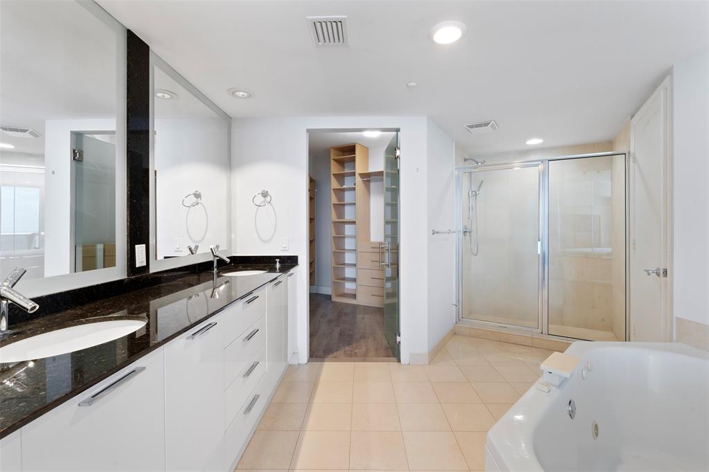 18911 Collins Avenue, Unit 3003 Sunny Isles Beach, FL 33160 - Photo 22 of 53 a spacious bathroom with a granite countertop sink mirror and shower
