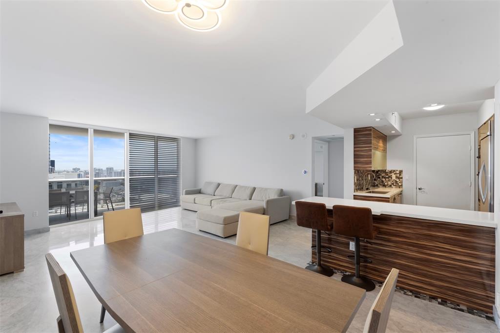 18911 Collins Avenue, Unit 3003 Sunny Isles Beach, FL 33160 - Photo 3 of 53 a living room with furniture and a table