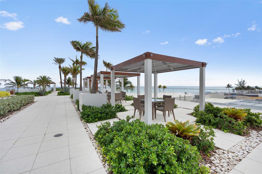 18911 Collins Avenue, Unit 3003 Sunny Isles Beach, FL 33160 - Photo 45 of 53 a view of a patio with a table and chairs under an umbrella