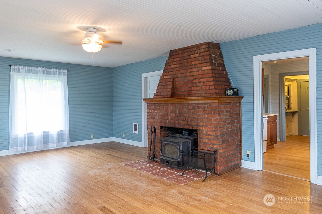 21801 Yeager Road Monroe, WA 98272 - Photo 3 of 13 a view of empty room with wooden floor and fireplace