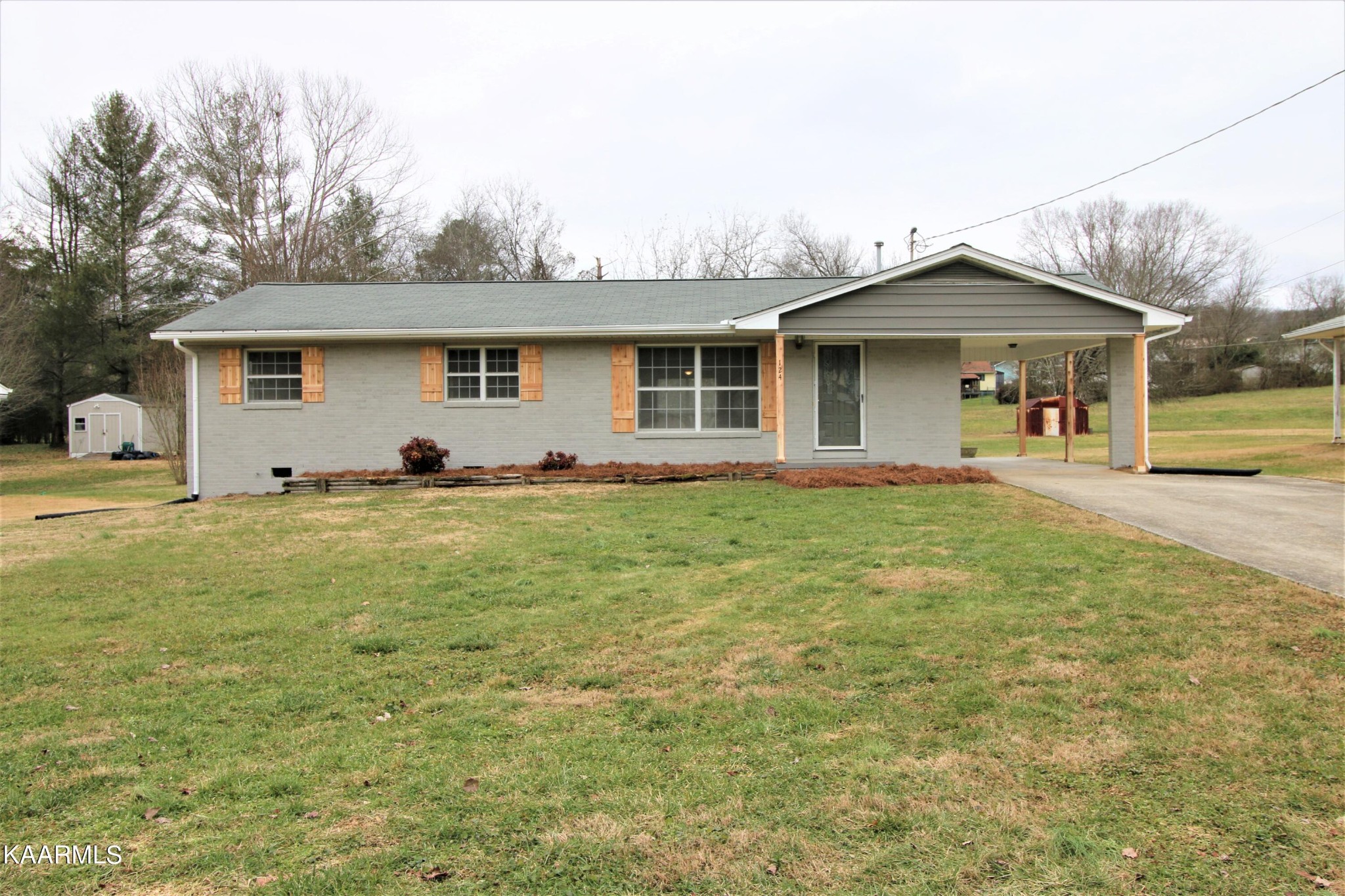 124 West Lincoln Road Oak Ridge, TN 37830 - Photo 1 of 27 a front view of house with yard and trees in the background