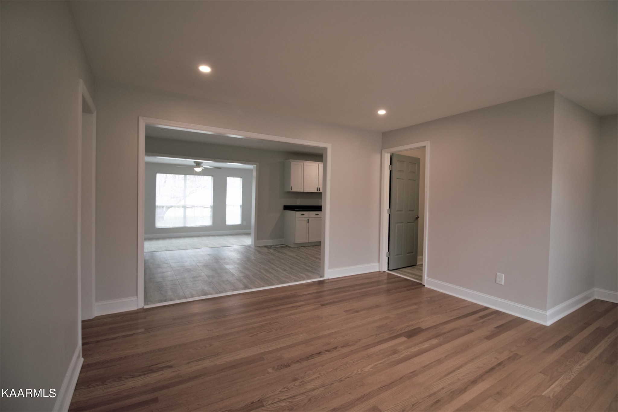 124 West Lincoln Road Oak Ridge, TN 37830 - Photo 18 of 27 a view of empty room with wooden floor and kitchen