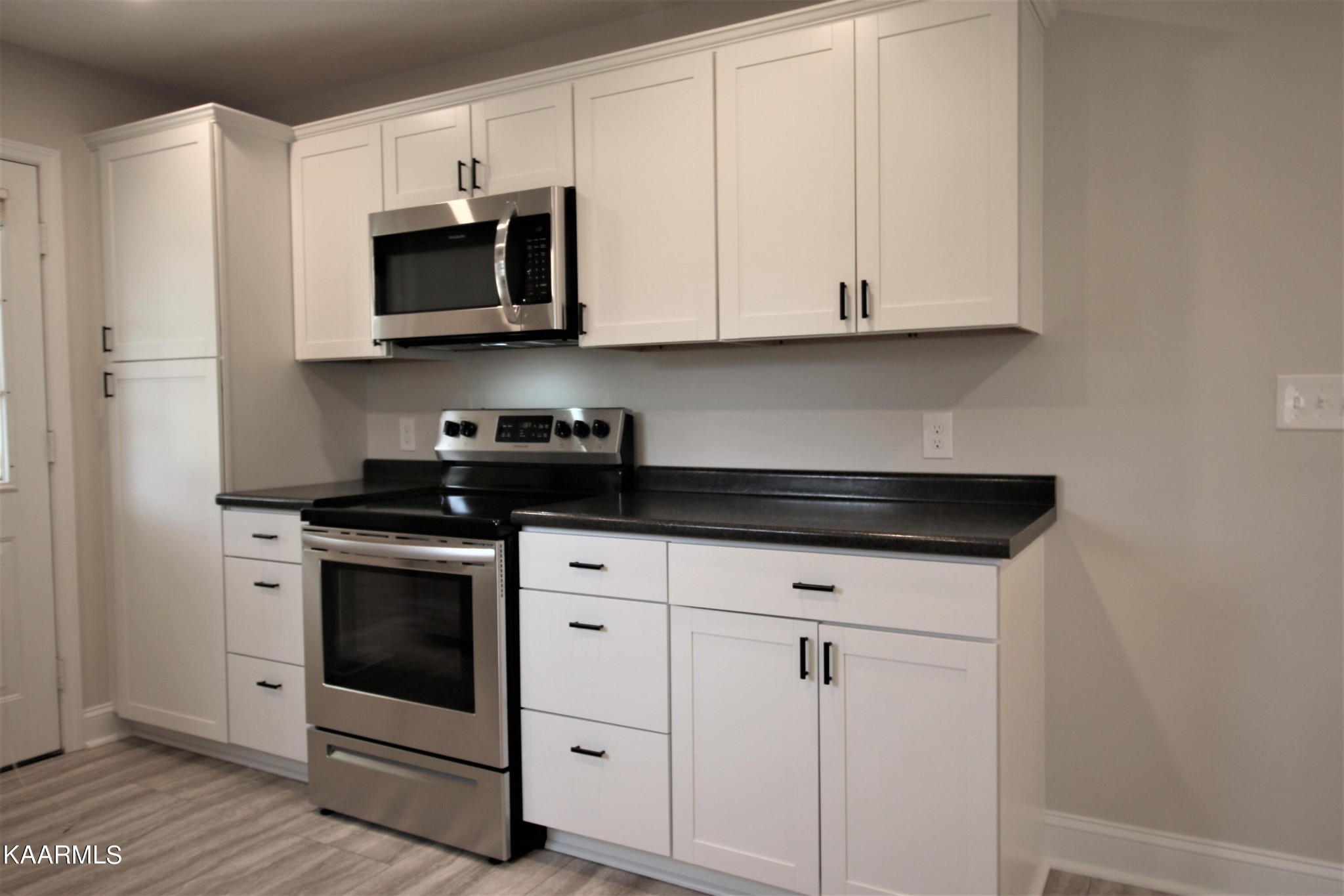 124 West Lincoln Road Oak Ridge, TN 37830 - Photo 23 of 27 a kitchen with stainless steel appliances granite countertop white cabinets sink and stove