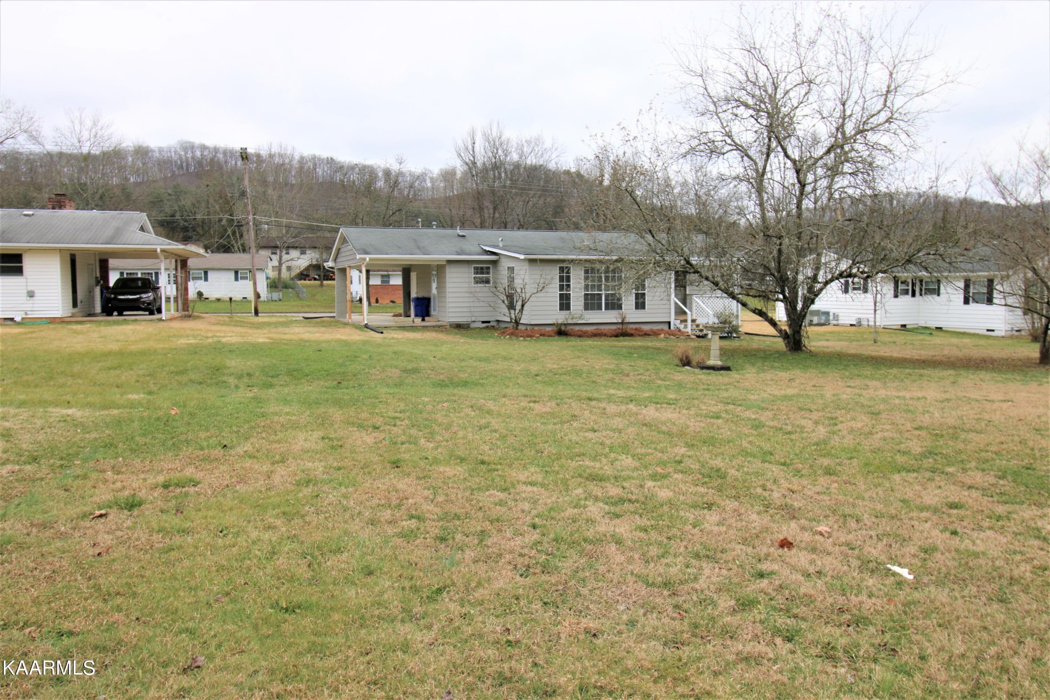 124 West Lincoln Road Oak Ridge, TN 37830 - Photo 3 of 27 a view of a big house with a big yard and large trees