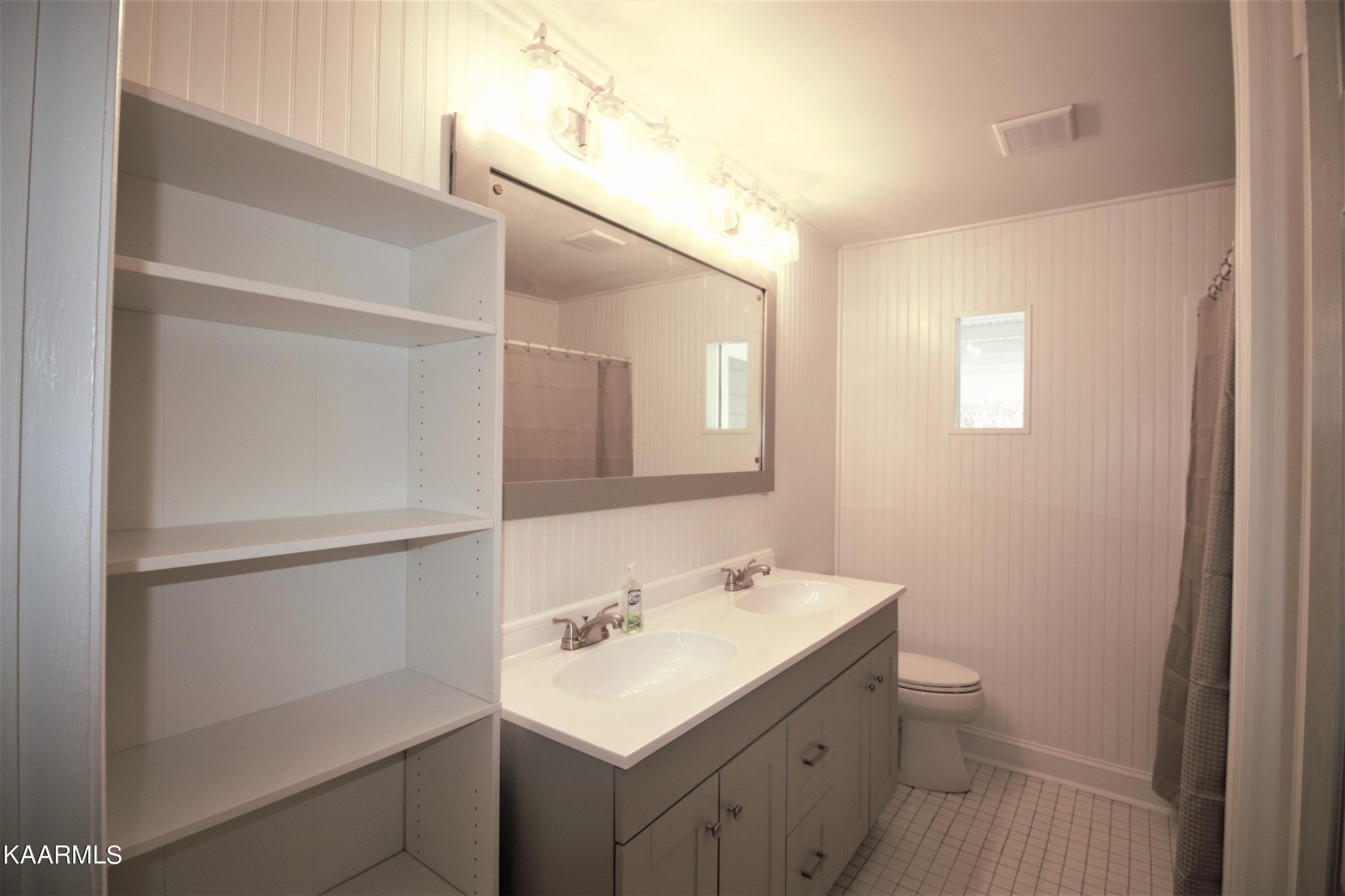 124 West Lincoln Road Oak Ridge, TN 37830 - Photo 6 of 27 a bathroom with a sink a toilet and mirror