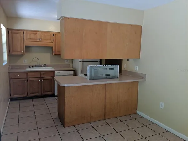 a kitchen with stainless steel appliances a sink stove and cabinets