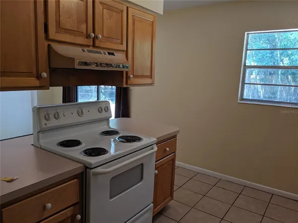 a kitchen with a stove and cabinets