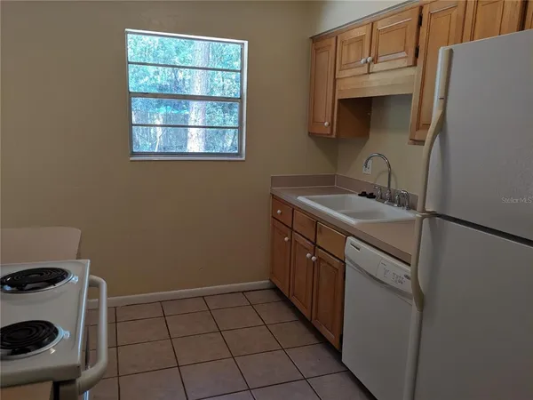 a kitchen with a sink a stove and a refrigerator