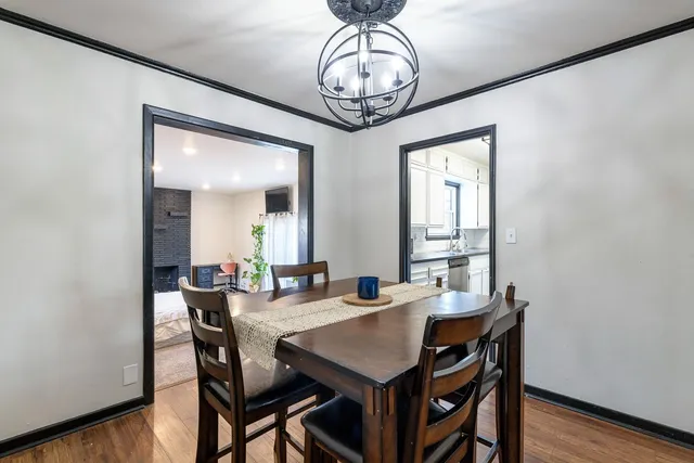 a view of a dining room with furniture wooden floor and chandelier
