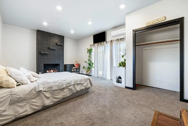 a spacious bedroom with a bed and a couch