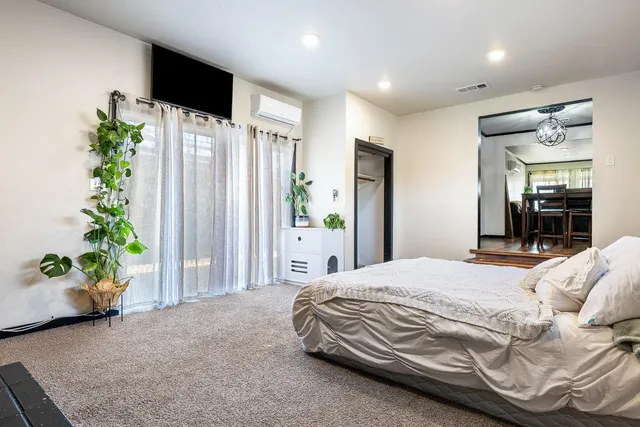 a bedroom with a bed and a potted plant
