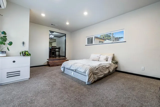 a spacious bedroom with a bed and a couch