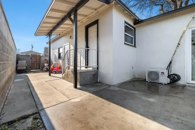 a view of a patio with table and chairs