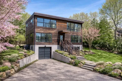 a view of a house with backyard and sitting area