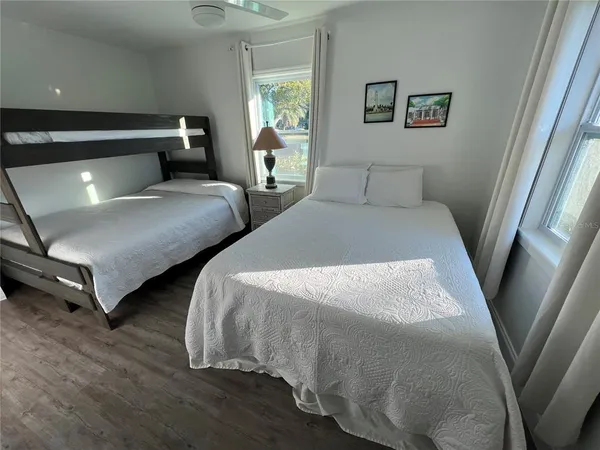 a bedroom with two beds and a chandelier
