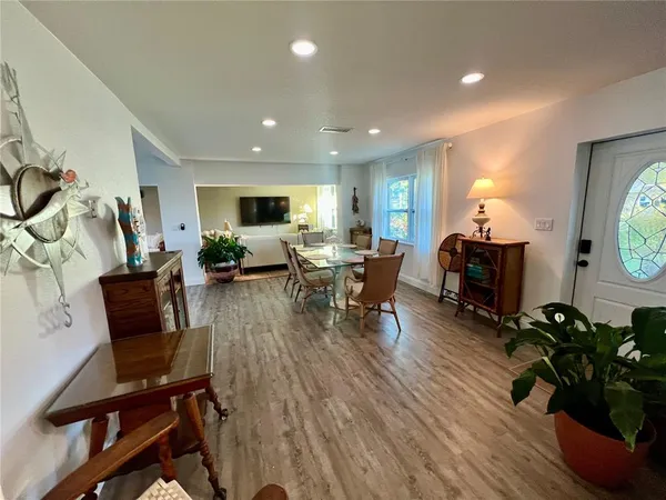 a living room with furniture a wooden floor and a flat screen tv