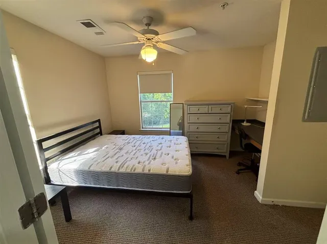 a bedroom with a bed and a window