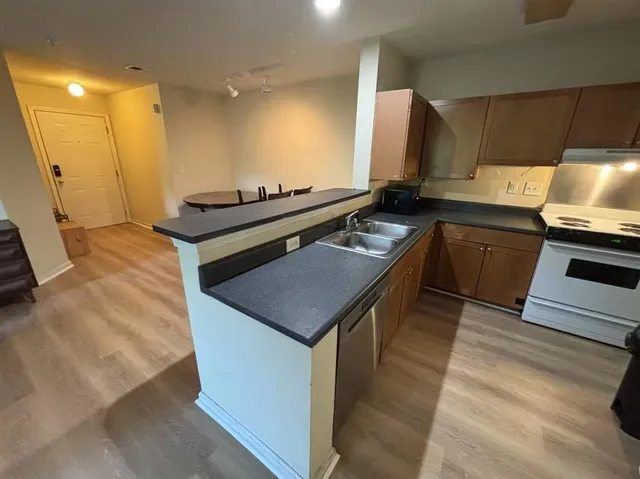 a kitchen with a sink stove and cabinets
