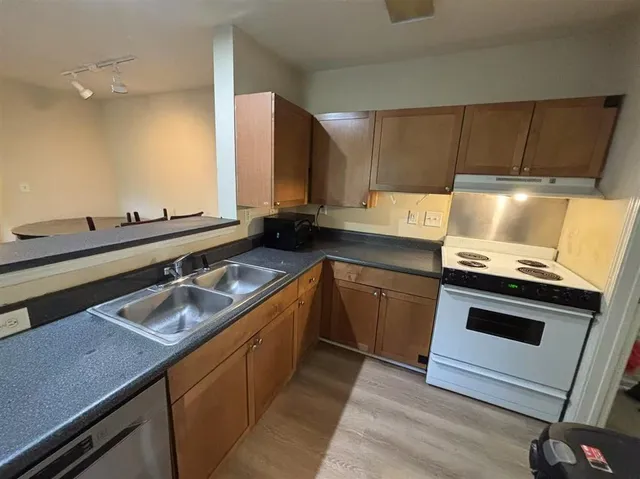 a kitchen with a sink stove and cabinets